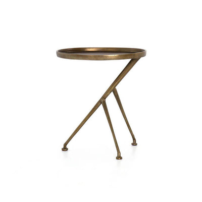 The Rostock Accent Table has a oval tabletop, tripod legs and is made of cast aluminum in a raw brass finish.