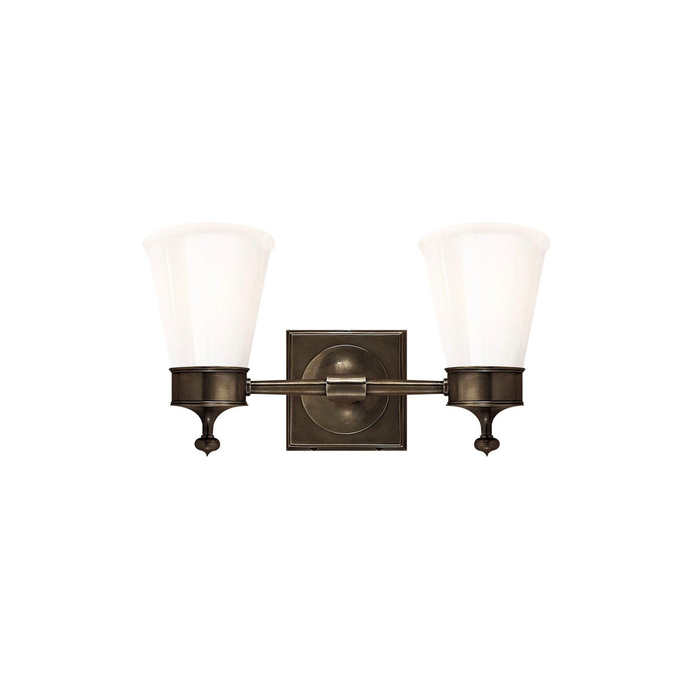 Double Sconce in Bronze combines classic details like finials with a white glass shade. To accent a bathroom vanity.