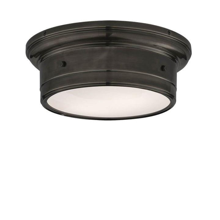 The Siena Flush Mount has a simple drum shape in a bronze finish with covered bolt details and a white glass diffuser