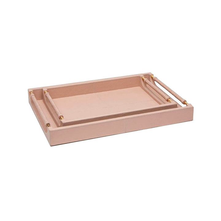 Stacked pink leather trays with brass hardware.