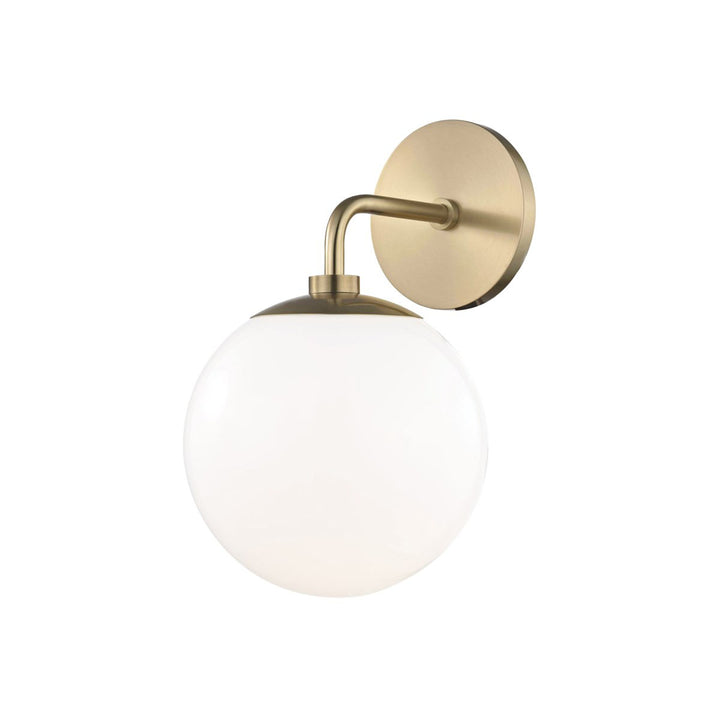 The Alyeska Wall Sconce in a aged brass finish with white glass globe shade.
