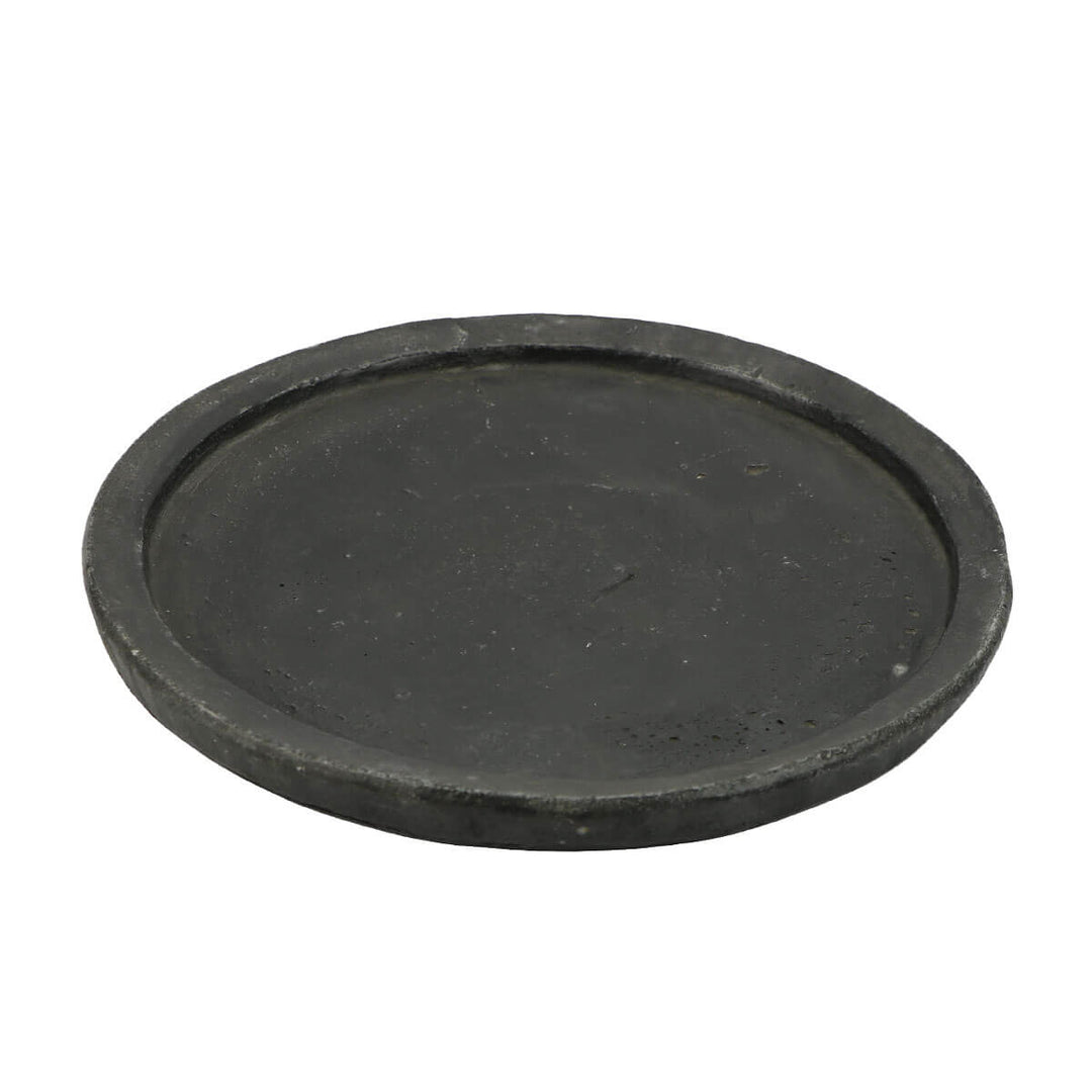Round stone plate hand-carved and sourced from India.