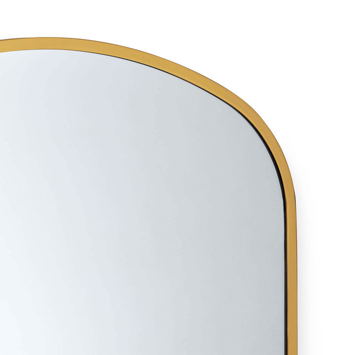 The curved arch of the Syros mirror adds a contemporary element to it's sleek, modern form. Natural Brass / Gold mirror.