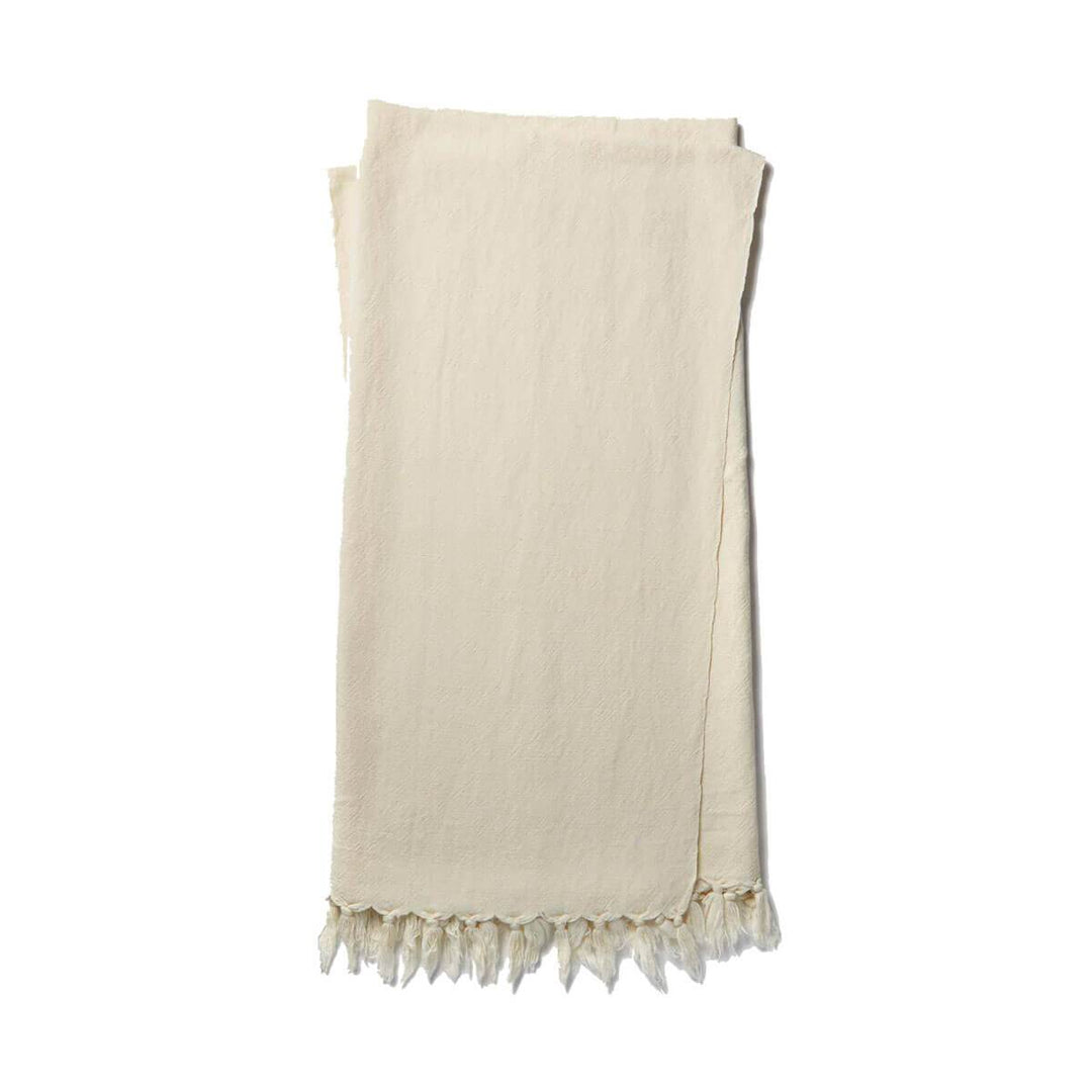 The Gobi Throw - Ivory is a simple ivory coloured, cotton and linen blanket with a fringe edge.