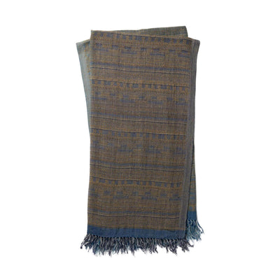 The Tejada Throw - Blue / Grey is a luxurious, wool and silk blend throw blanket with a blue and grey, ancient tribal pattern.