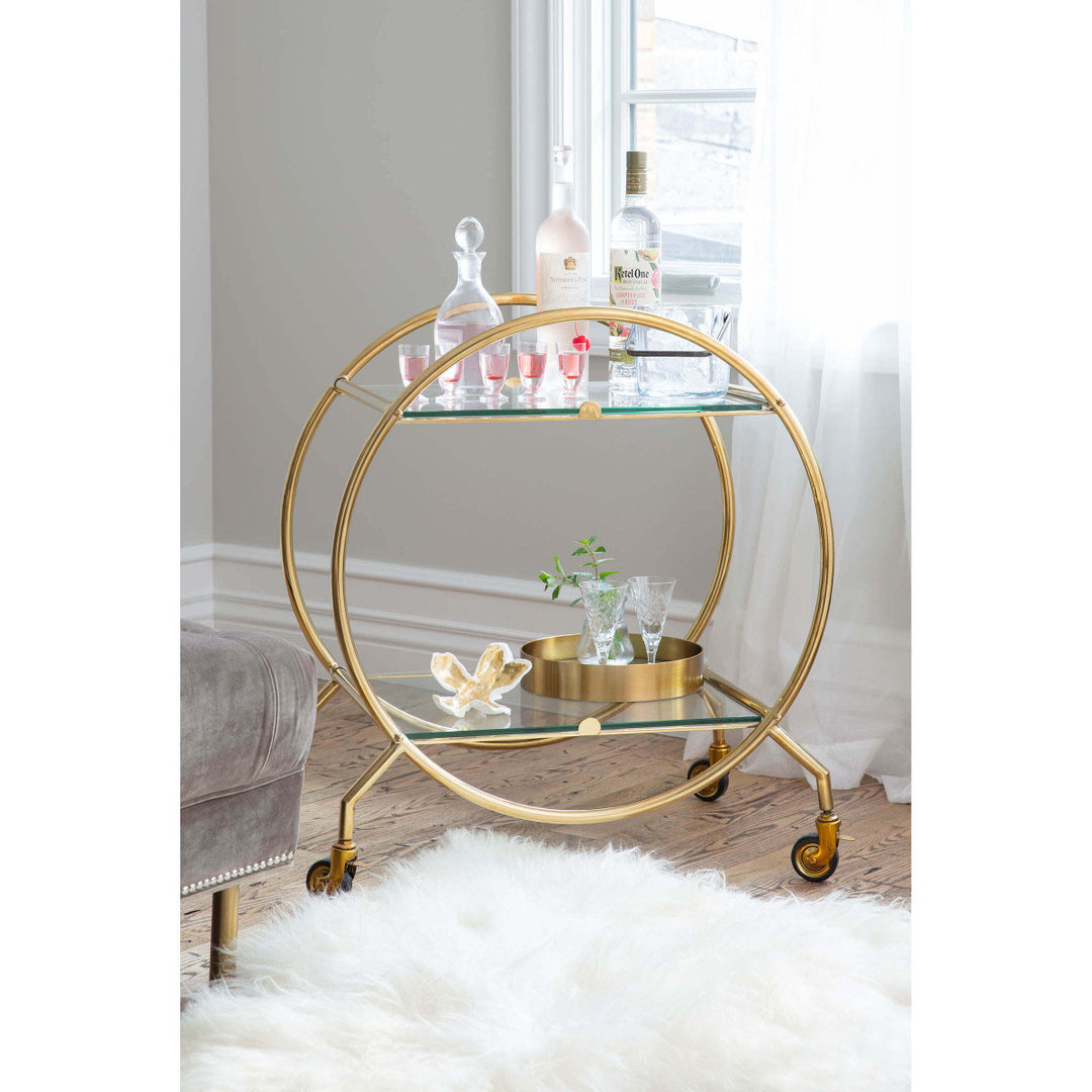 Round serving tray on a midcentury modern bar cart.