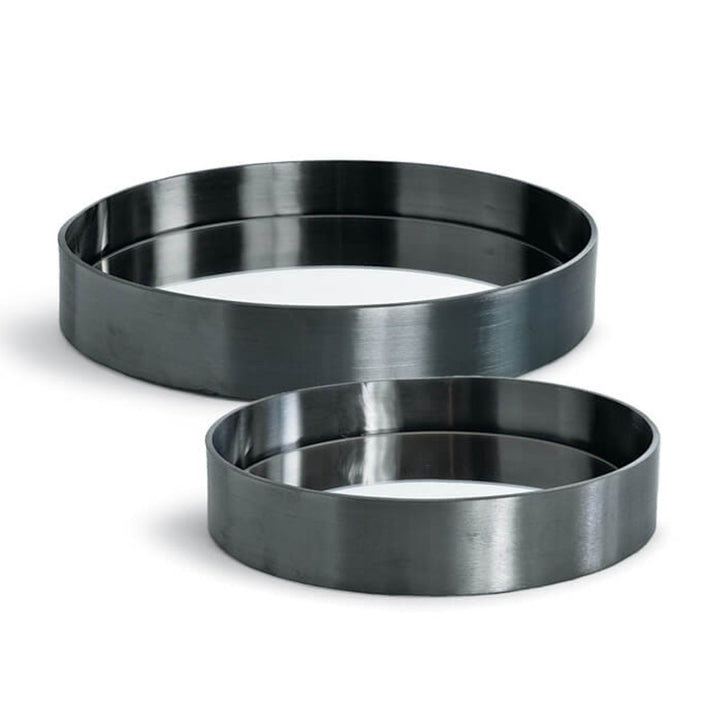 The Barcelona Tray Set is a set of two round serving trays in a blackened steel finish.