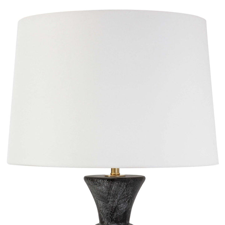 Modern white lamp shade and slender black base on a modern table light.