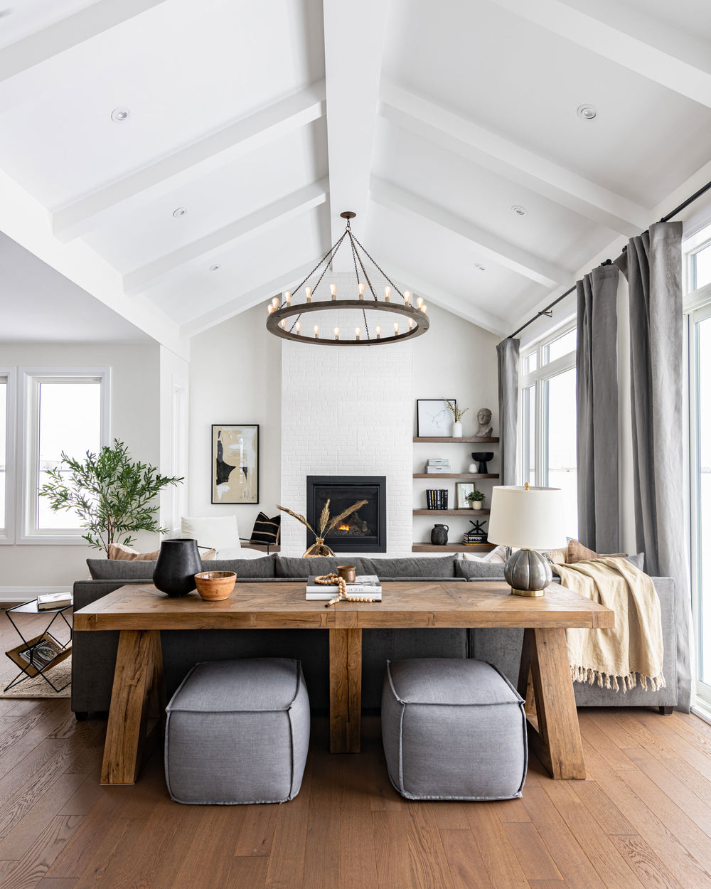 Oversized pendant in living room with wooden ring and evenly spaced bulbs with a medieval look.