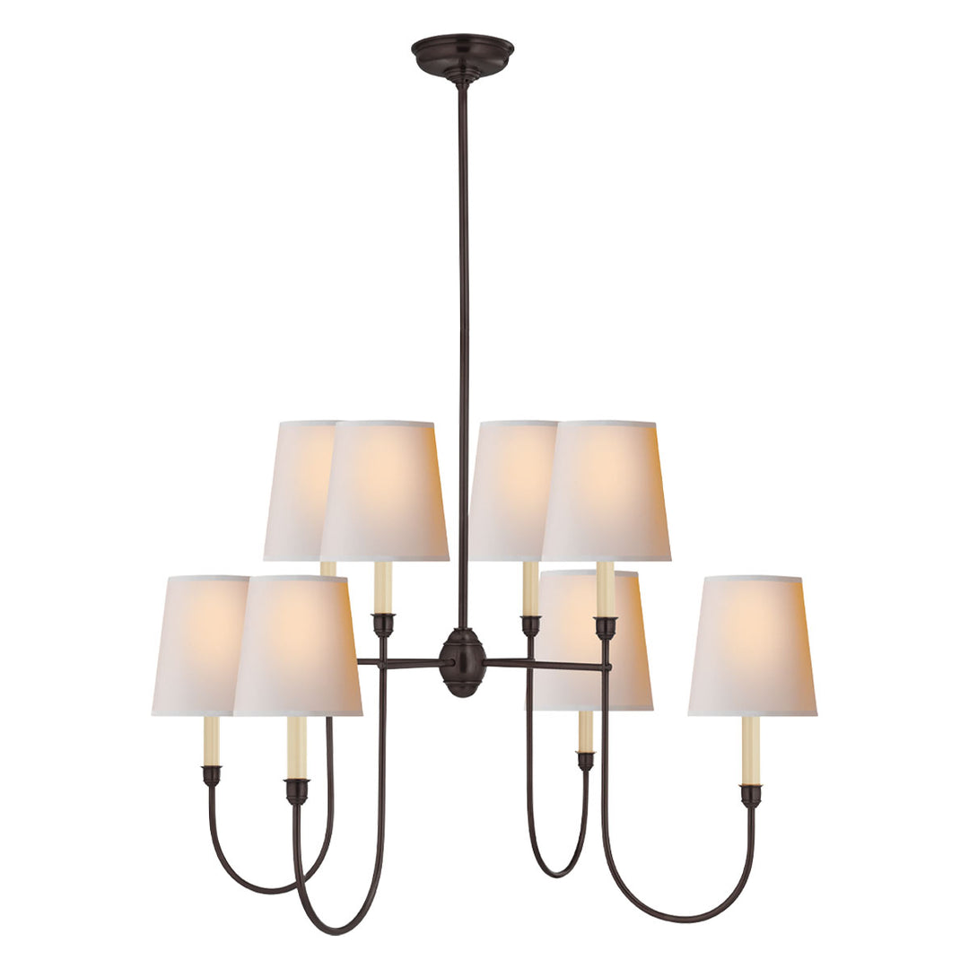 A dramatic, 8-bulb large chandelier finished in a bronze with natural paper shades.