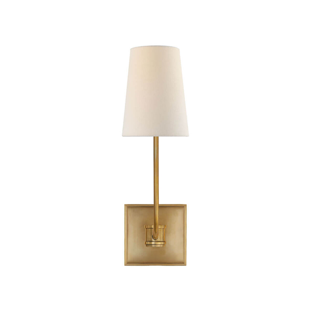 The Venini Wall Sconce is a square, antique burnished brass backplate and slightly curved arm with a single linen shade.