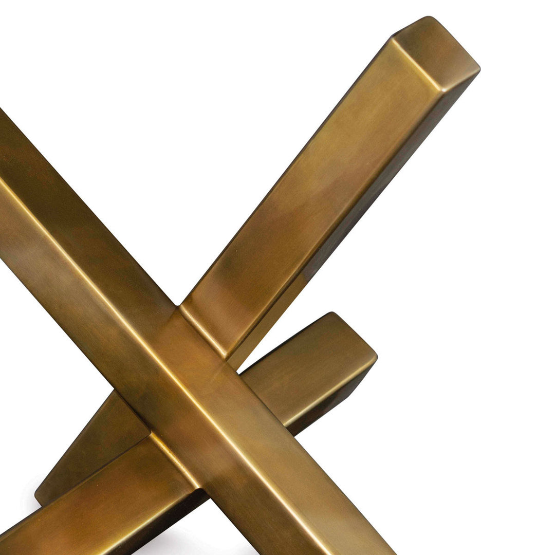 Close up of the intersecting forms that makes this modern brass sculpture.