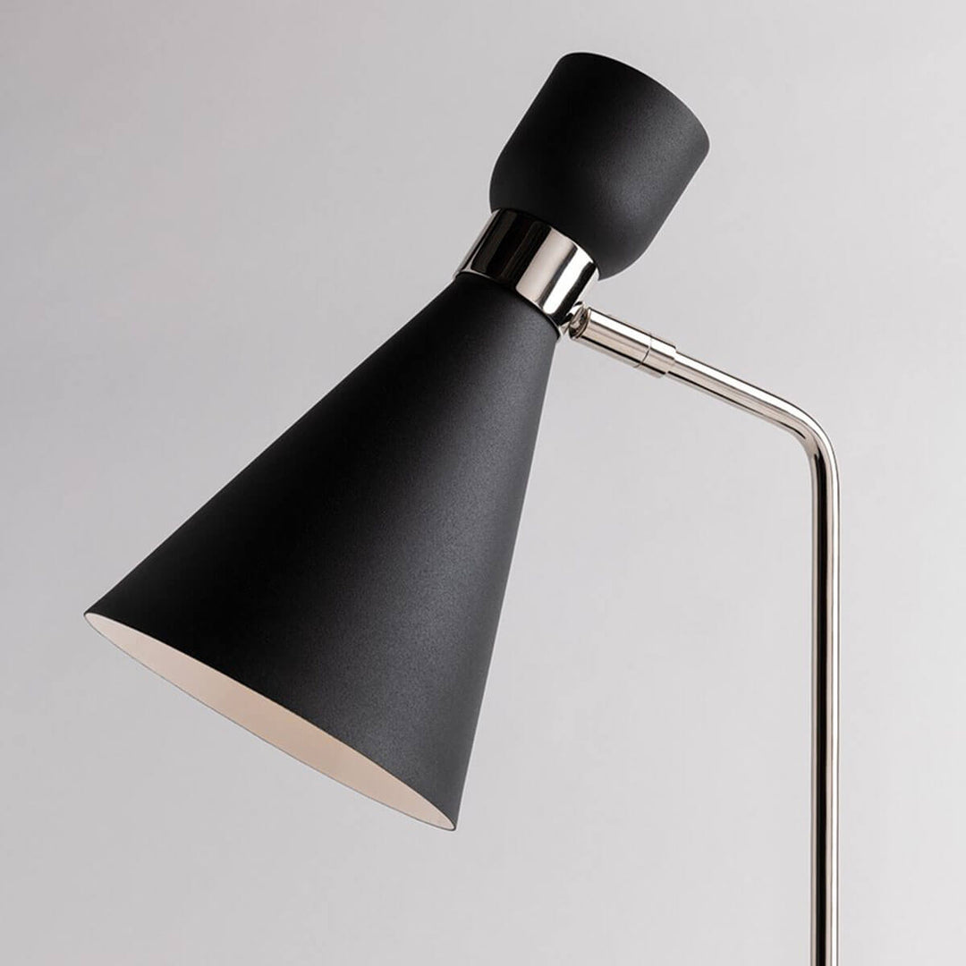 Tapered lamp shade and adjustable swivel arm on a black modern wall sconce.