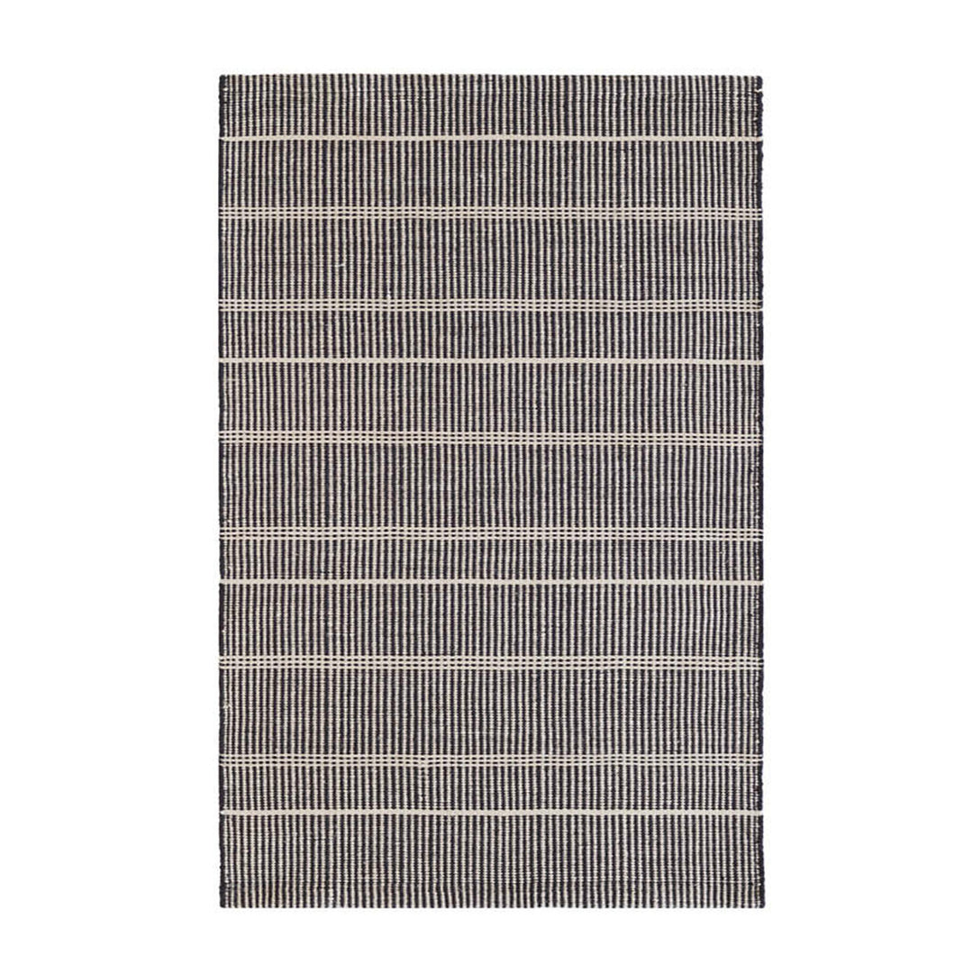 Wool-like, durable, eco-friendly polyester striped black outdoor rug made from recycled bottles.