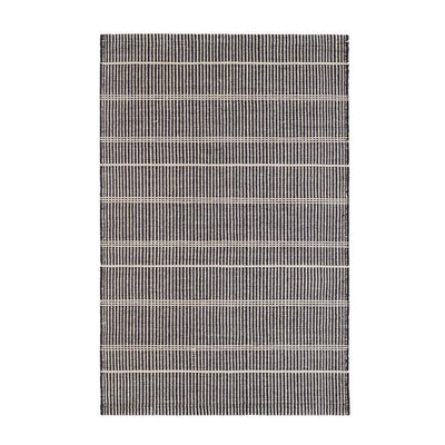 Wool-like, durable, eco-friendly polyester striped black outdoor rug made from recycled bottles.