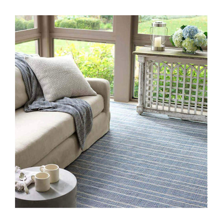 Navy Indoor / Outdoor Rug. Striped blue and white rug for a comfortable seating area on a patio.