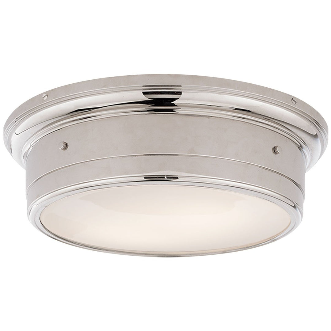 The Siena Flush Mount in Large has a simple drum shape in Polished Nickel finish with covered bolt details and a white glass diffuser.